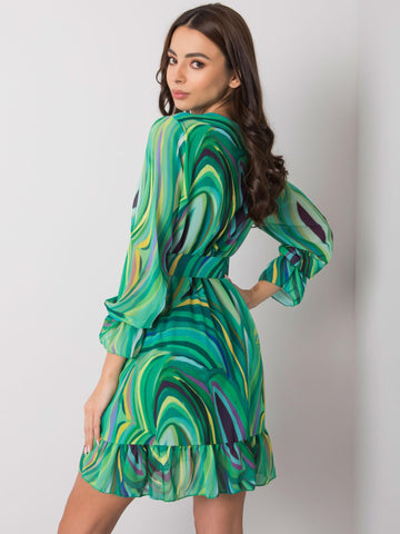Green patterned dress with a Kerley belt.